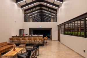 a lobby with a bar and tables and chairs at Merino Inn Hotel in Colesberg