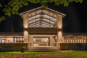 a house with a lit up facade at night at Merino Inn Hotel in Colesberg