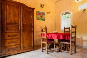 a dining room with a red table and chairs at Bastide Du Maoupas Gîtes in Belgentier