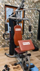 a gym with a red chair in a room at Moti Manas Mansion - A Homestay in Gwalior in Gwalior