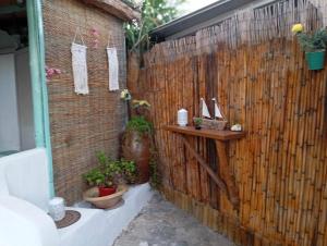 a brick wall with a shelf and plants on it at MANOS Small House Kouremenos in Palekastron