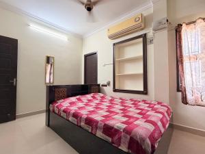 a bedroom with a bed and a window and a mirror at Royal Paradise Inn in Chidambaram
