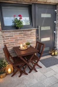 a wooden table and two chairs on a patio at Abby Apartment Koper in Koper