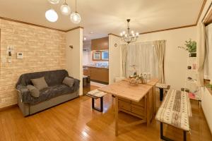 a living room with a couch and a table at Villa上条 名古屋から30分本格ガスグリルでBBQができる宿 in Kasugai