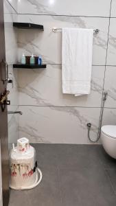 a bathroom with a sink and a toilet and towels at Moti Manas Mansion - A Homestay in Gwalior in Gwalior +56 photos