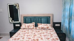 a bedroom with a bed with two pillows at Moti Manas Mansion - A Homestay in Gwalior in Gwalior