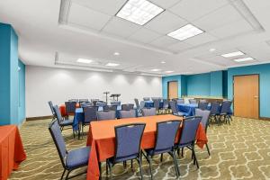 a conference room with a table and chairs at Comfort Suites Sanford in Sanford