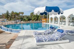 a pool with two lounge chairs and an umbrella at Kalithea Horizon Blu - Adults Only in Kallithea Rhodes