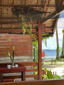 a bench with a view of the beach and the ocean at Camp Olli Beach Villas in Dapa +21 photos