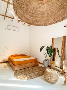 a bedroom with a bed and a rattan ceiling at Hide Boutique Villas in Weligama