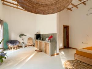 a living room with a large ceiling at Hide Boutique Villas in Weligama