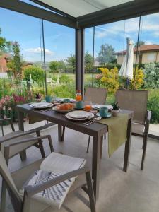 a table with food on it on a patio at Il Giardino di Sofia B&B in Piozzo +14 photos