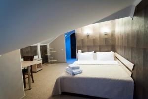 a bedroom with a bed and a desk in a room at Harvest in Vinnytsya +41 photos