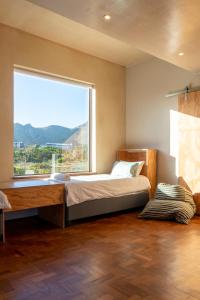 a bedroom with a bed and a large window at The Dunes Pringle Bay in Pringle Bay