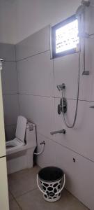 a small bathroom with a toilet and a shower at Kanchan Grace in Vaduvanchal