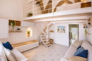 a living room with a loft bed and a staircase at 4sisters' Open Space in Aradeo