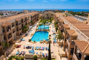 an aerial view of a resort with a pool and buildings at Sunshine Royal Seacrest- Prime Location Paphos with Pool in Paphos