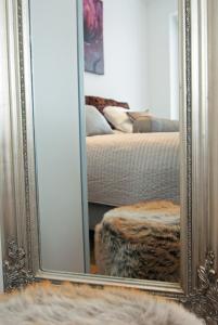 a mirror in front of a bedroom with a bed at Molenberg in Middelburg