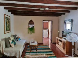 a living room with a couch and a table at Cortijo Paraiso Pool & Tropical Garden Oasis in Cúllar de Baza