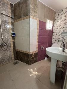 a bathroom with a sink and a shower at Kışla Pansiyon in Antalya