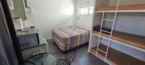 a small room with a bed and a desk at Rivergums Caravan Park in Goondiwindi +15 photos