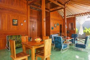 a dining room with a table and chairs at Villa Joglo Kawung - City Centre Paradise with Pool in Yogyakarta