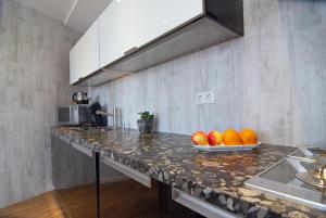 a kitchen with a counter with oranges on it at Molenberg in Middelburg