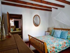 a bedroom with a bed and a table and a mirror at Cortijo Paraiso Pool & Tropical Garden Oasis in Cúllar de Baza +47 photos