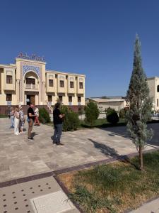 a group of people standing in front of a building at Premium Ark Hotel in Bukhara