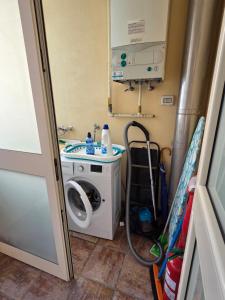 a washing machine in a room with a washer at Taormina Panoramic Apartment - Taormina Holidays in Taormina