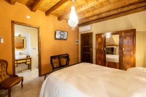 a bedroom with a large bed and a bathroom at Ca'trecamini in Ca Dolfin