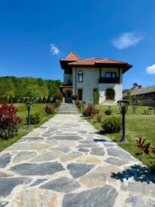 a stone walkway leading to a house at Casa Tudorescu in Horezu