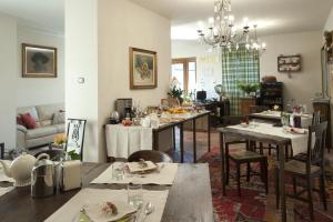a living room with tables and a dining room at Agriturismo Rivella in Barbaresco