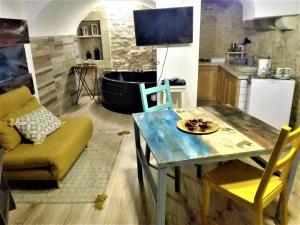 a kitchen with a table and a bath tub at Only for two Giumbabulla in Ragusa