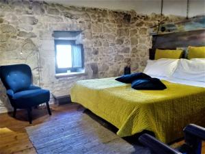 a bedroom with a bed and a chair and a window at Only for two Giumbabulla in Ragusa +60 photos