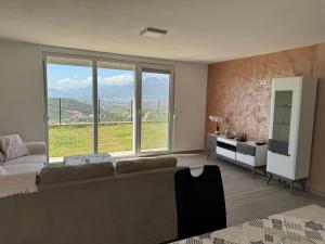 a living room with a couch and a large window at Bela Bar in Pečurice +6 photos