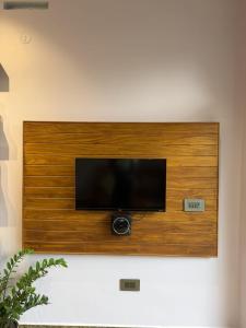 a flat screen tv mounted on a wall at Bella Casa in Vagamon