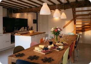 a wooden table with food and wine glasses on it at Chalet Broski - Spacious Chalet with Hot Tub, Sauna & BBQ in Planvillard