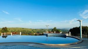 a large swimming pool with a view of the mountains at Highland Park Mondulkiri in Phumĭ Pu Klé (2)