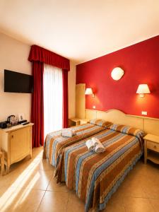a hotel room with a bed with a stuffed animal on it at B&B Marina Sleep And Ship in Rodi Garganico