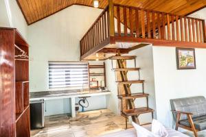 a room with a desk and a spiral staircase at Highland Park Mondulkiri in Phumĭ Pu Klé (2)