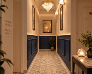 a hallway of a hotel with a chandelier at Hotel Granton By Carlton Suites in Hyderabad