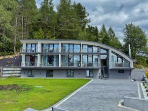 a large house with a large round building with windows at VELAR Apartment in Skhidnitsa