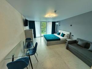 a living room with a bed and a couch at VELAR Apartment in Skhidnitsa