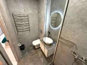a bathroom with a sink and a toilet and a mirror at VELAR Apartment in Skhidnitsa +32 photos