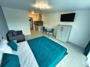 a bedroom with a bed and a living room at VELAR Apartment in Skhidnitsa
