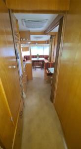 an empty room with a hallway with a dining room at Quiet caravan in nature on Mur cycle path in Feldkirchen bei Graz