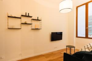 a living room with two shelves and a tv at Moulin -Old Town in Nice