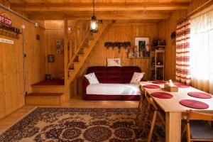 a living room with a bed and a staircase at Casa Bando in Moacşa