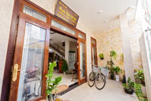a store front with a bike parked outside of it at Hoi An Legend Connect Villa in Hoi An +7 photos